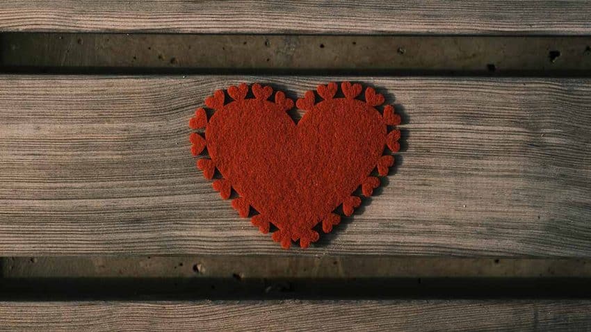 Un corazón de tela sobre una madera